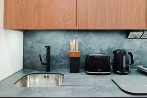 a kitchen counter with a sink and a toaster at Apex Studios by Derbnb in Derby