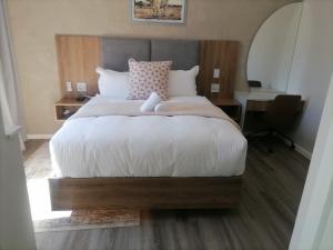 a bedroom with a bed with a teddy bear on it at Going places BnB in Queenstown