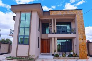 a house with large windows on top of it at DDS Homes Apartments in Dodoma