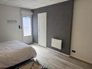 a bedroom with a bed and a window and a door at Studio in Remiremont