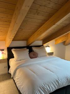 a large bed with white sheets and pillows at Sogno La Vigna - Adults Only in Montegrosso dʼAsti