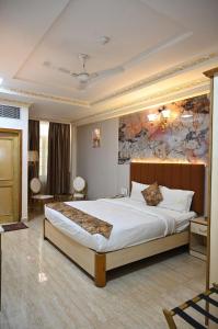 a bedroom with a large bed in a room at HOTEL GALAXY GRAND in Lucknow