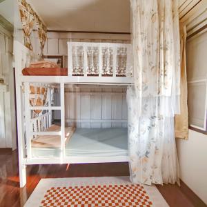 a room with a bed and a curtain at NiranHouse Hostel in Sathani Phitsanulok