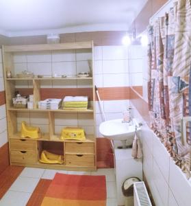 a small bathroom with a sink and a sink at Virág Apartmanház in Sopron