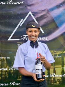 a boy in a bow tie holding a toy gun at Fortunas Resort Nkubu, Meru in Nkubu +91 photos