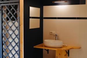 a bathroom with a white sink on a wooden table at Domek gdzie śpią żurawie in Szymbark +71 photos