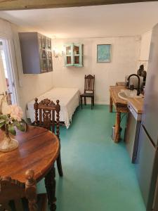 a bedroom with a bed and a sink in a room at Gruse 9 Svaneke in Svaneke