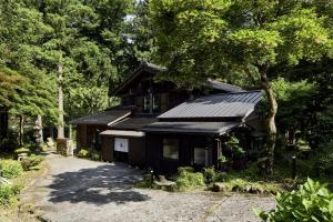 a black house with a lot of trees at YADO SEN -仙- Komatsu in Komatsu