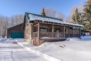 a log cabin in the snow with snow at 20 mins to YNP-Cabin-Pet friendly in Island Park