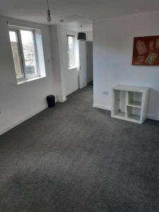 an empty room with white walls and a table at OG Box in Bolton