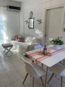a living room with a bed and a table and chairs at NiRa house in Pefkochori +24 photos