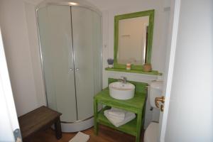 a bathroom with a sink and a toilet and a mirror at Pensiunea Talhaus in Vişeu de Sus