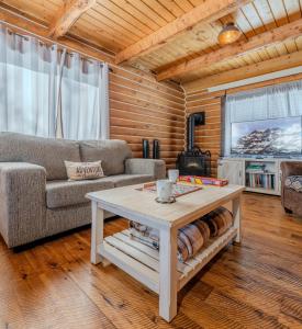 a living room with a couch and a coffee table at 20 mins to YNP-Cabin-Pet friendly in Island Park