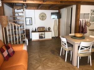 a living room with a couch and a table at La casetta di Vany in Nova Siri