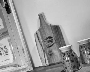 a wooden vase sitting on a shelf next to two vases at LAne Têtu in Désaignes +1 photo