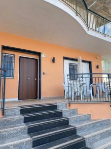 a staircase leading up to a house with a table and chairs at B&B Costa d'Amalfi Bellizzi in Bellizzi