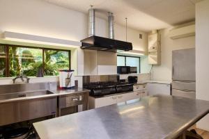 a kitchen with a stainless steel counter top at YADO SEN -仙- Komatsu in Komatsu