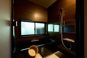 a bathroom with a toilet and a shower and a window at YADO SEN -仙- Komatsu in Komatsu +15 photos