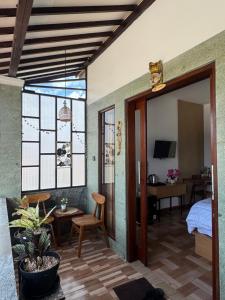 a room with a bedroom and a bed and a table at Holi Saren Guest House in Nusa Dua
