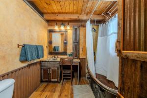 a bathroom with a sink and a mirror at 20 mins to YNP-Cabin-Pet friendly in Island Park +26 photos