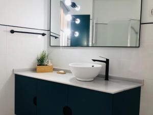a bathroom with a sink and a mirror at La casa grande 2 in Carmona