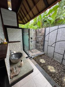 a bathroom with a sink and a shower at The Jingga Villas in Nusa Lembongan +36 photos