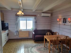 a living room with a table and a couch at Nordfjord Charm in Stårheim