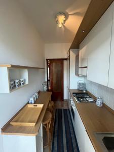a kitchen with white cabinets and a counter top at La dolce vela in Muggia