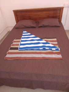 a bed with an american flag quilt on it at Amaya Hotel and Restaurant in Batigama