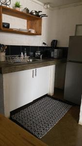 a kitchen with a sink and a kitchen rug at 201 On Main in Johannesburg