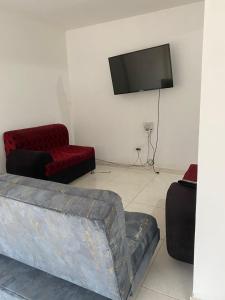 a living room with a couch and a flat screen tv at Apto Albor Blanco in Popayan