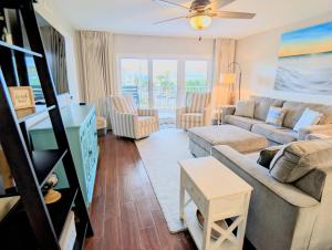 a living room with a couch and a table at Gulf Balcony - Boutique Comforts & 2 King Suites in Fort Walton Beach