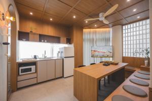 a kitchen with a table and a ceiling fan at 아랑재 arangjae in Seoul