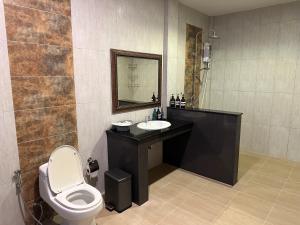 a bathroom with a toilet and a sink and a mirror at Tsuya Hill Private Mountain View Villa, Chiang Rai in Mae Chan +10 photos