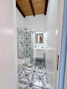 a bathroom with a tub and a toilet and a sink at La Casa al Mare Vulcano in Vulcano +81 photos