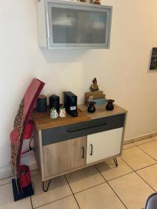 a room with a table with a tv on the wall at LE MERYCE appt in Saint-Denis +2 photos
