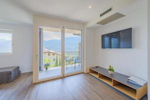 a living room with a large sliding glass door at Tholr - Ferienwohnungen - Tramin in Termeno