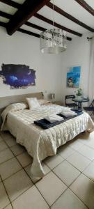 a bedroom with a bed and a chandelier at B&B Pierilu' in Grosseto