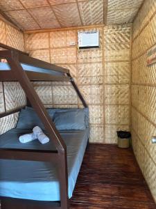 a small room with a bunk bed in a brick wall at D Bamboo House in Mabini +18 photos