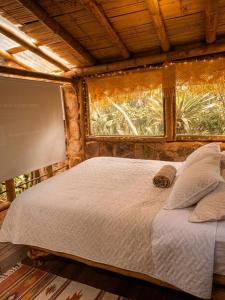 a large bed in a room with a window at Bosque Hondo Ecoliving in Medellín
