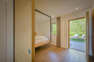 a bedroom with a bed and a mirror at Tholr - Ferienwohnungen - Tramin in Termeno +161 photos