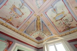 a ceiling in a building with paintings on it at Hotel Palazzo Vittoria Heritage Collection in Cerveteri