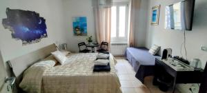 a bedroom with a bed and a couch in it at B&B Pierilu' in Grosseto