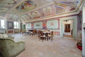 a living room with a ceiling with paintings on it at Hotel Palazzo Vittoria Heritage Collection in Cerveteri