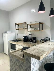 a kitchen with a counter top and a refrigerator at Dunas residence casa 15- Lençois Maranhense in Santo Amaro
