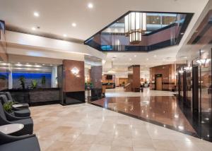 a lobby of a hotel with chairs and a staircase at Duplex Close to HPU Waikiki Pool Terrace Laundry One and Half Bath for 15person in Honolulu +65 photos