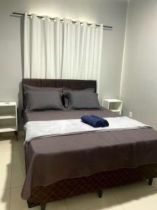 a bed in a bedroom with a blue towel on it at Dunas residence casa 15- Lençois Maranhense in Santo Amaro +42 photos