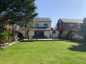 a house with a large lawn in front of it at The Dales in Marshside
