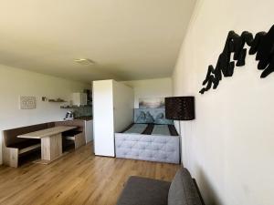 a small room with a bed and a table at Seestern Strobl in Strobl