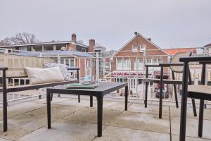 a table and chairs on top of a balcony at Atlantic Dependance Travemünde in Travemünde +1 photo